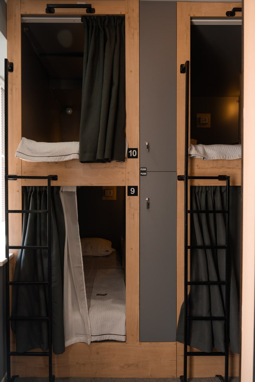 Общая комната The Traveler House с локерами и капсульными кроватями